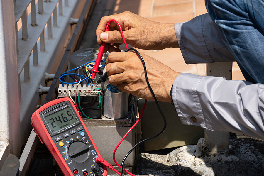 technician hands close up with tools repairing gate access control system san marcos tx